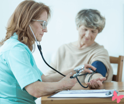 Doctor checking the blood pressure of a patient, wondering how she can help her naturally lower her high blood pressure